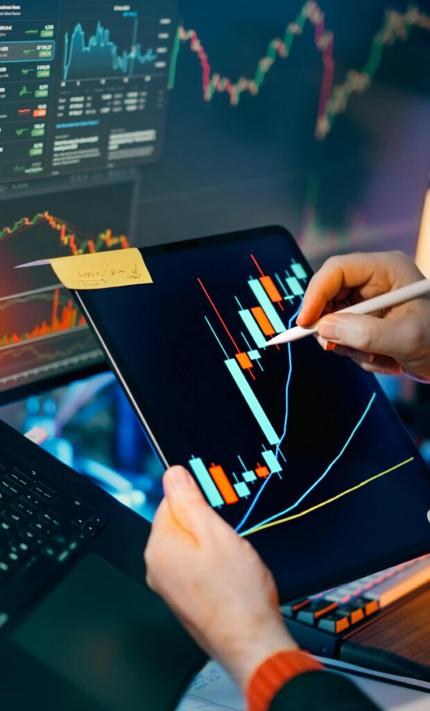 pexels photo 35638638 35638638 Person using a tablet to analyze financial charts for trading insights. Perfect for finance and technology themes.