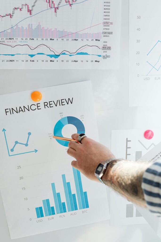 pexels photo 7876380 7876380 Hand pointing at a financial chart on a wall, illustrating data analysis and review.