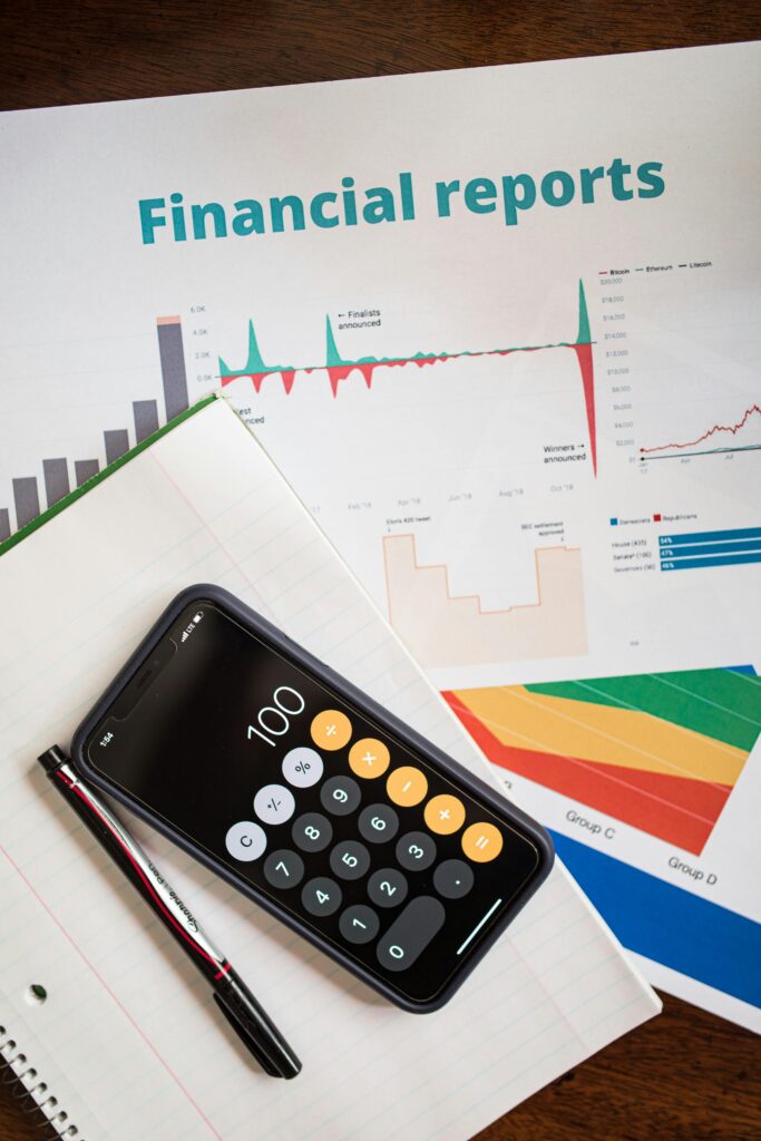 pexels photo 7947637 7947637 Top view of financial reports with a calculator app open on a smartphone.